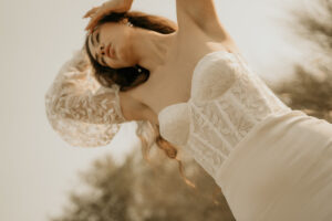 artistic photo of a modern embroidered wedding dress with puff sleeves shot from below as part of a brand editorial photoshoot