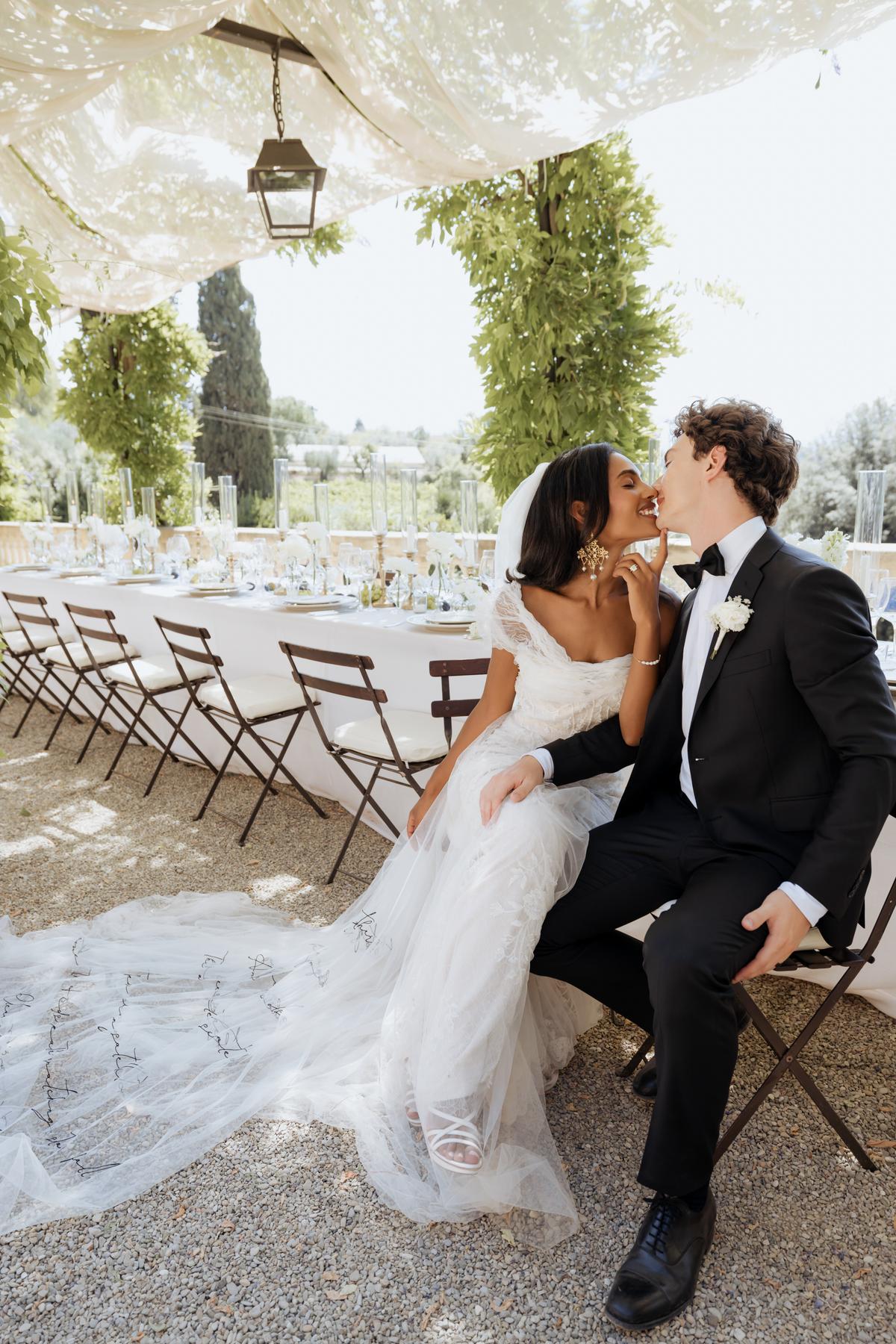 Modern bride styled by Joanna Southwell kisses her groom at their wedding in Tuscany